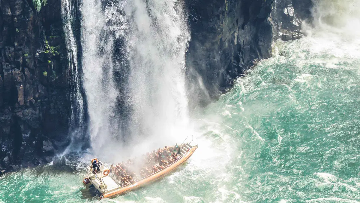 Twin-engine Macuco Safari boat approaching the spray below the falls on an Iguazu Falls boat tour on the Brazilian side
