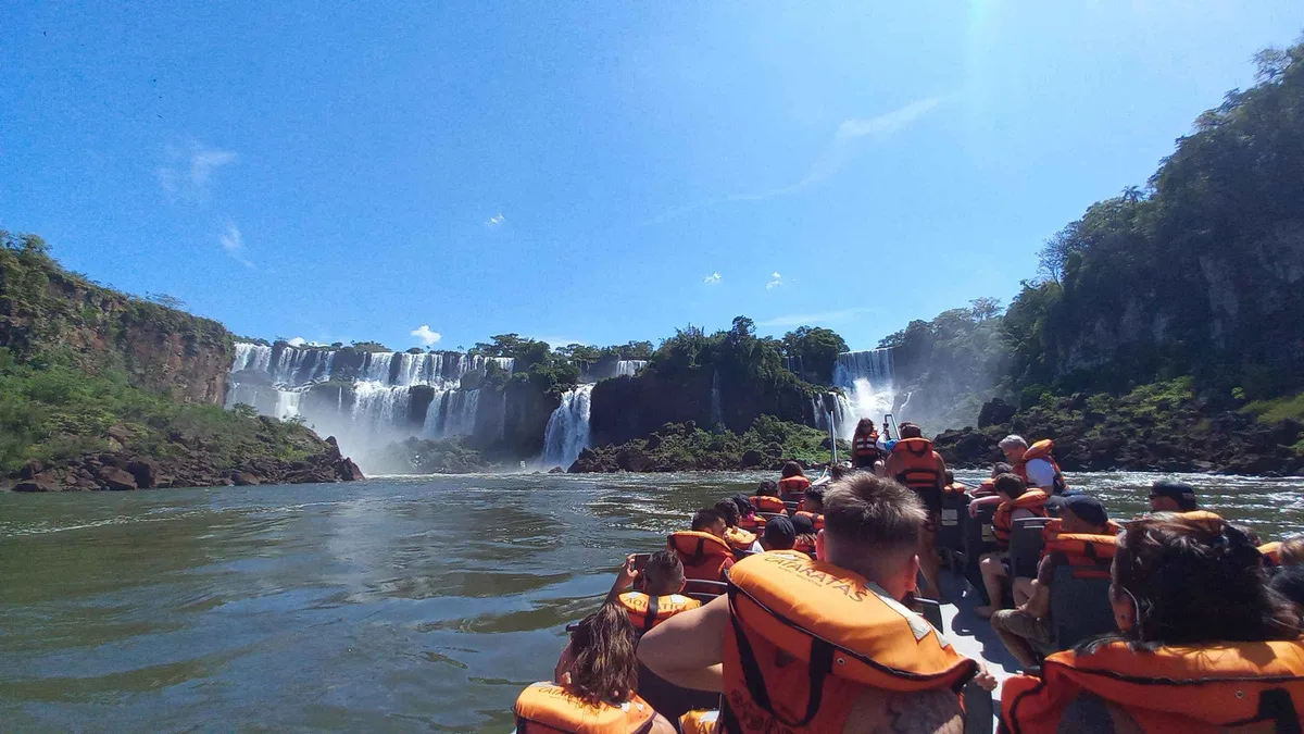 Open safari truck on a forest track carrying passengers to the river for an Iguazu Falls boat tour on the Argentine side