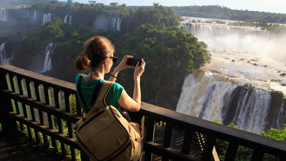Passengers holding a waterproof dry bag on a safari truck before an Iguazu Falls boat tour from Puerto Iguazu